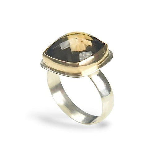 A cushion cut smoky quartz ring with a gold fill setting on a sterling silver band.
